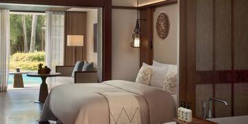 a room with a bed and a ceiling fan