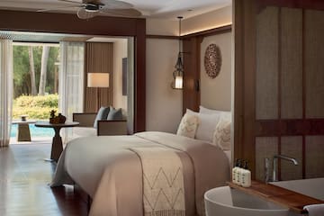 a room with a bed and a ceiling fan