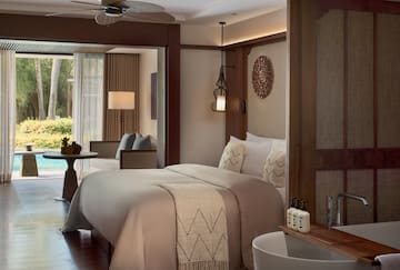 a room with a bed and a ceiling fan