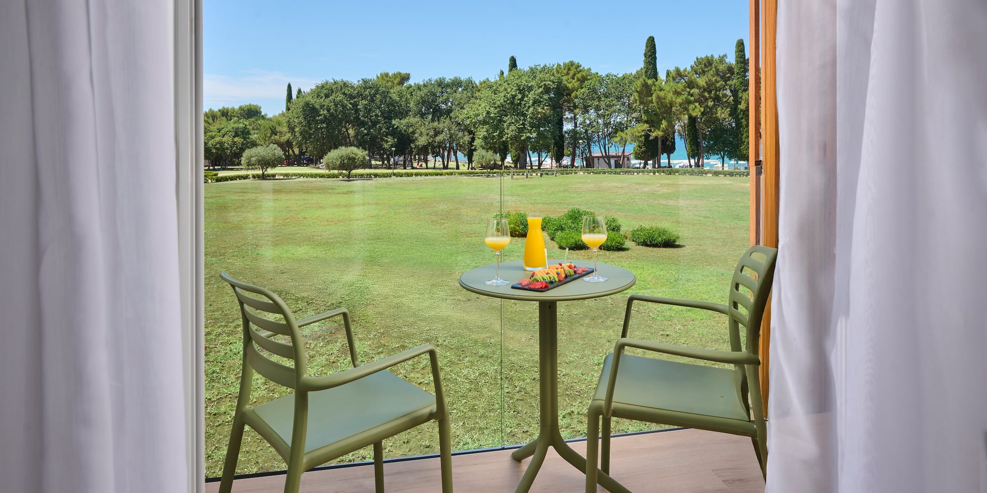 a table and chairs outside a window