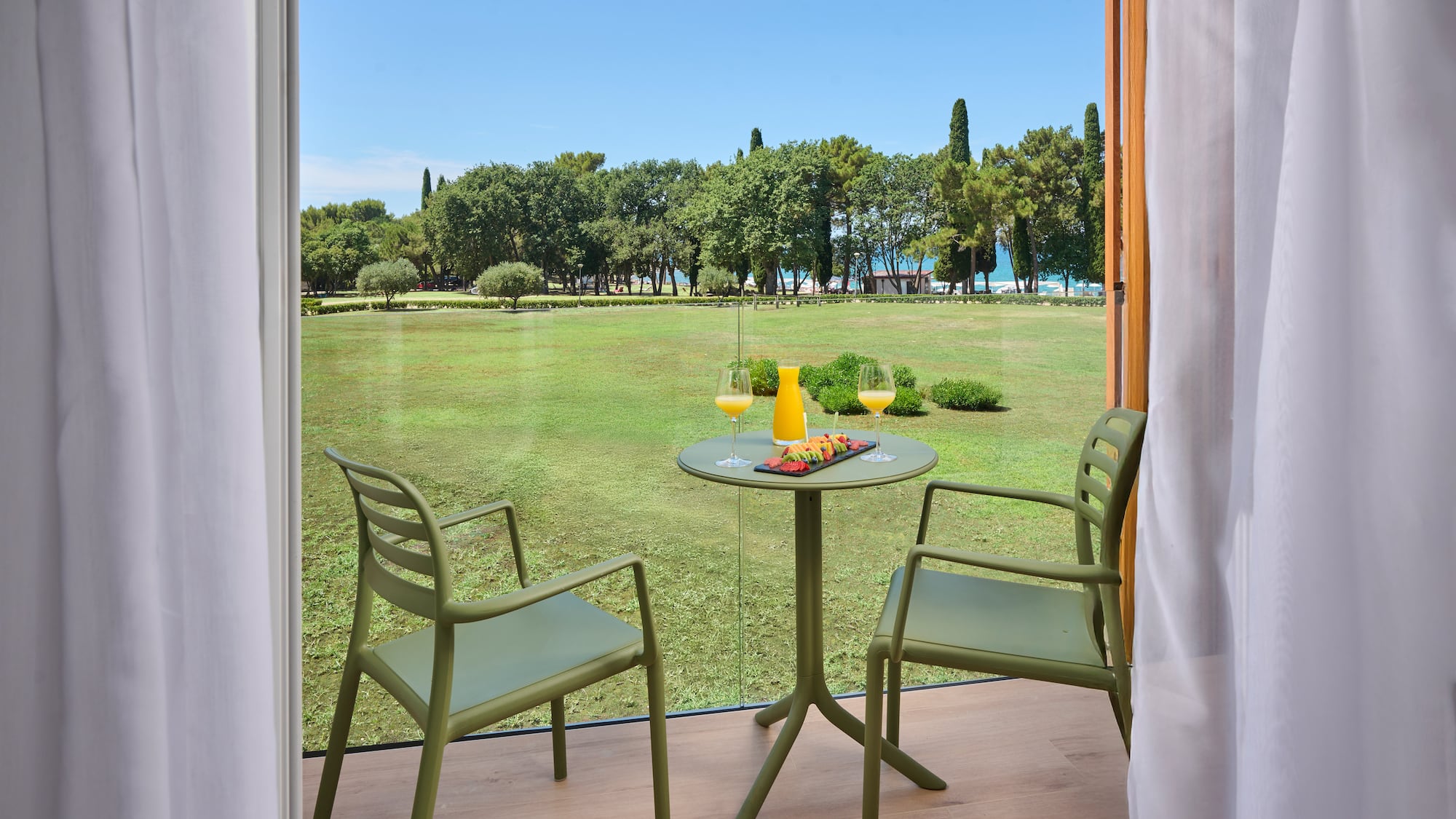 a table and chairs outside a window