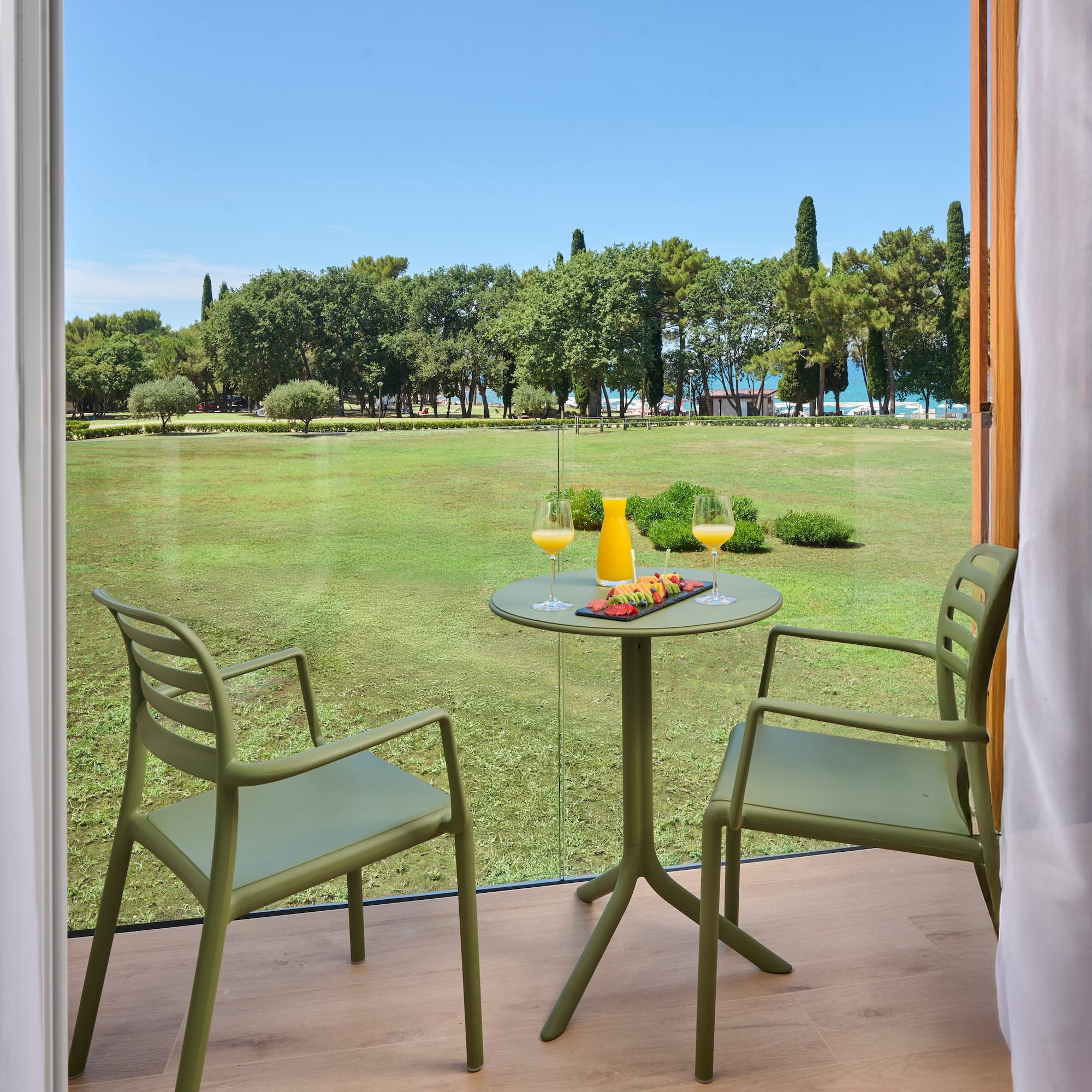 a table and chairs outside a window