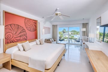 a room with a bed and a ceiling fan