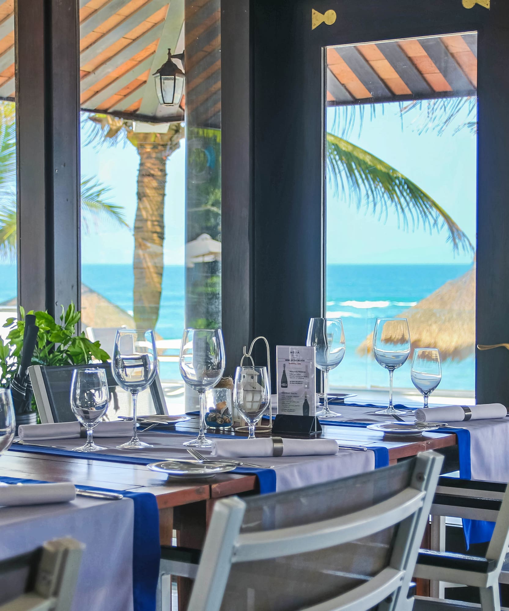 a table set for a dinner with a view of the ocean