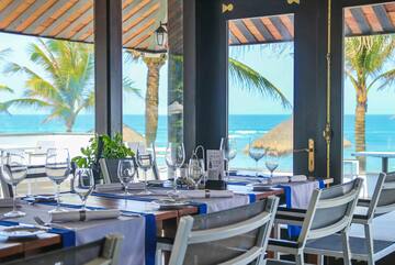a table set for a dinner with a view of the ocean