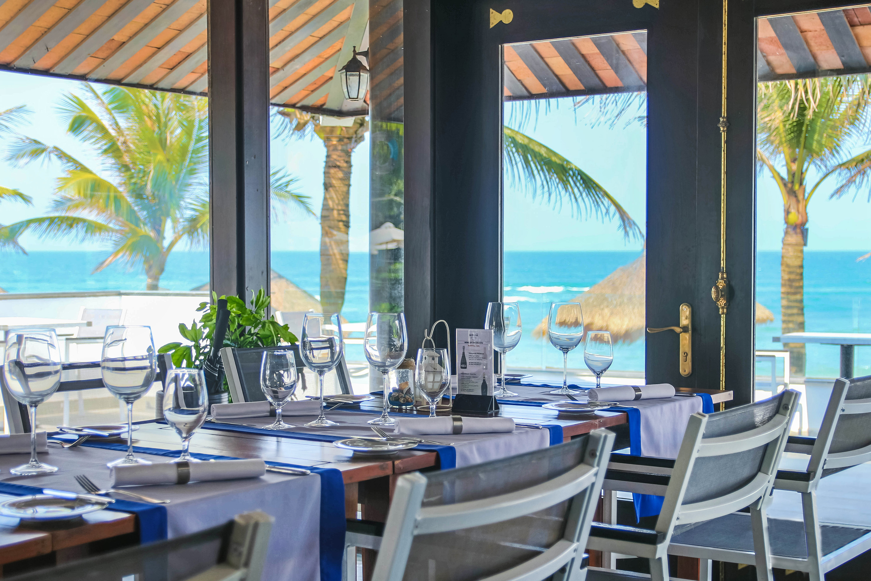 a table set for a dinner with a view of the ocean