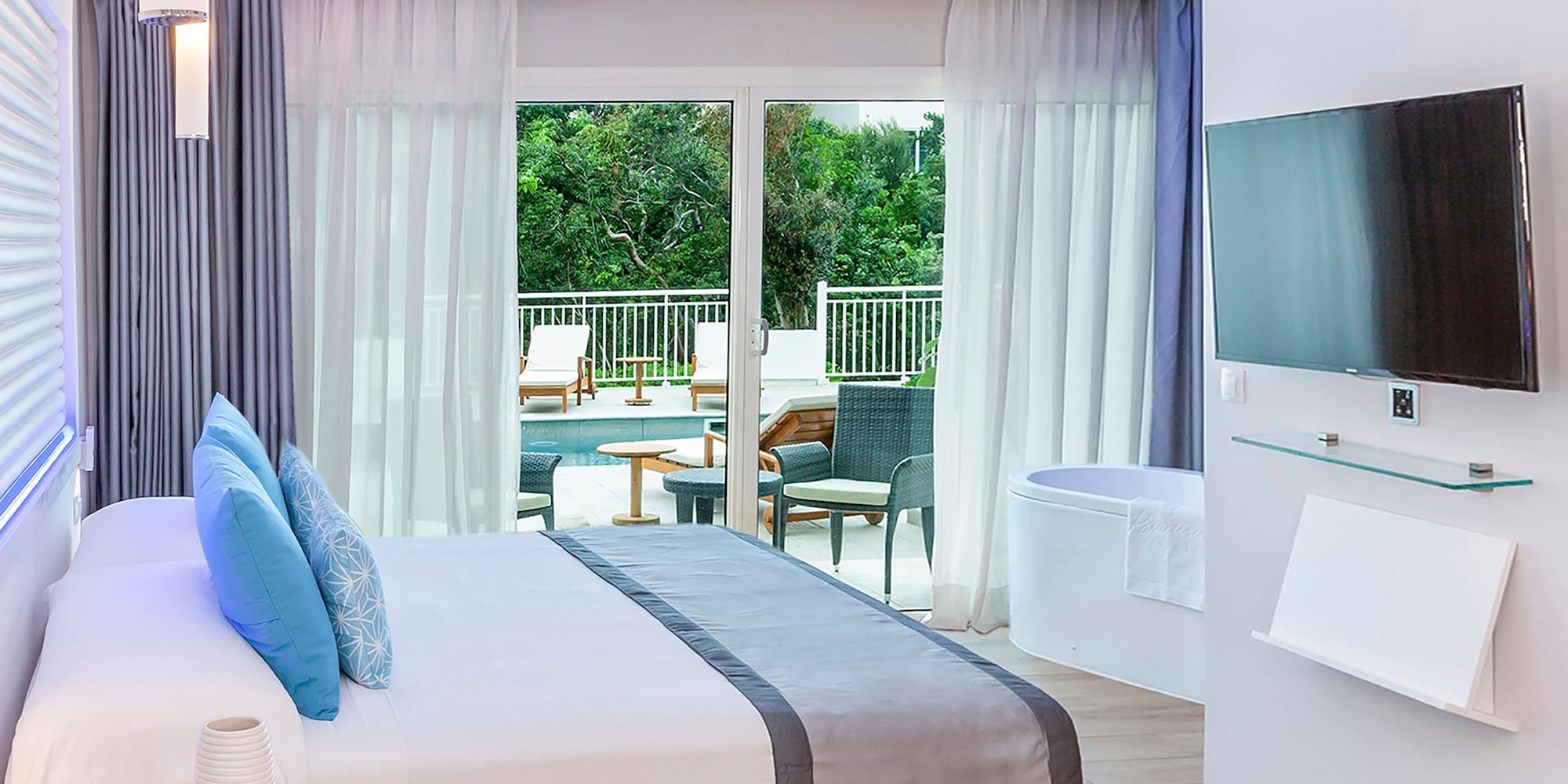 a bedroom with a large bed and a tub