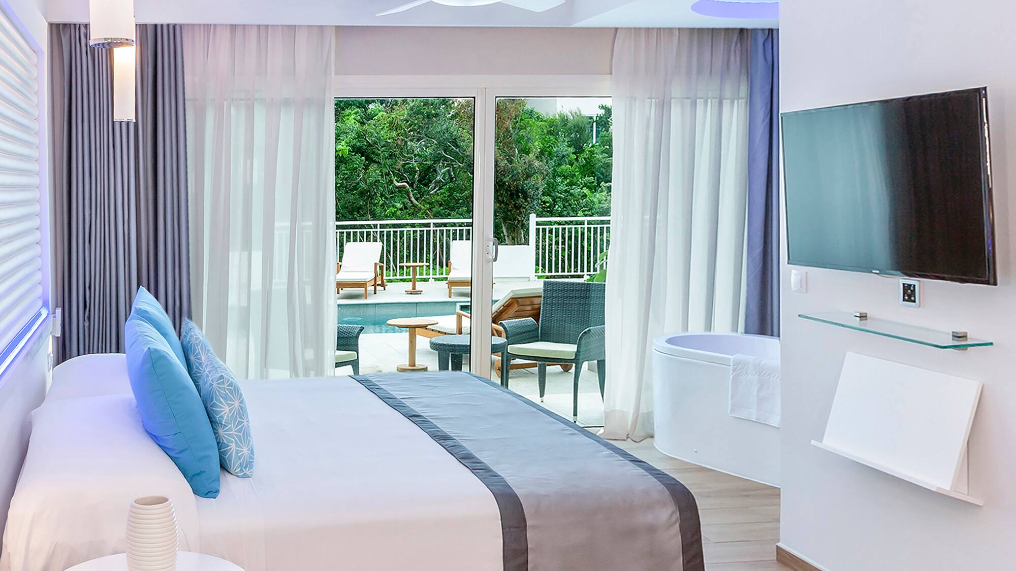 a bedroom with a large bed and a tub