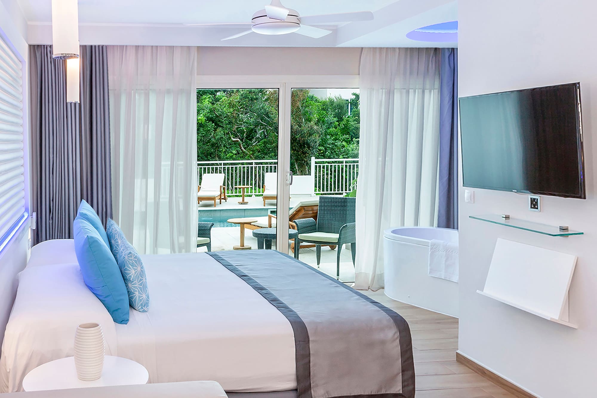 a bedroom with a large bed and a tub