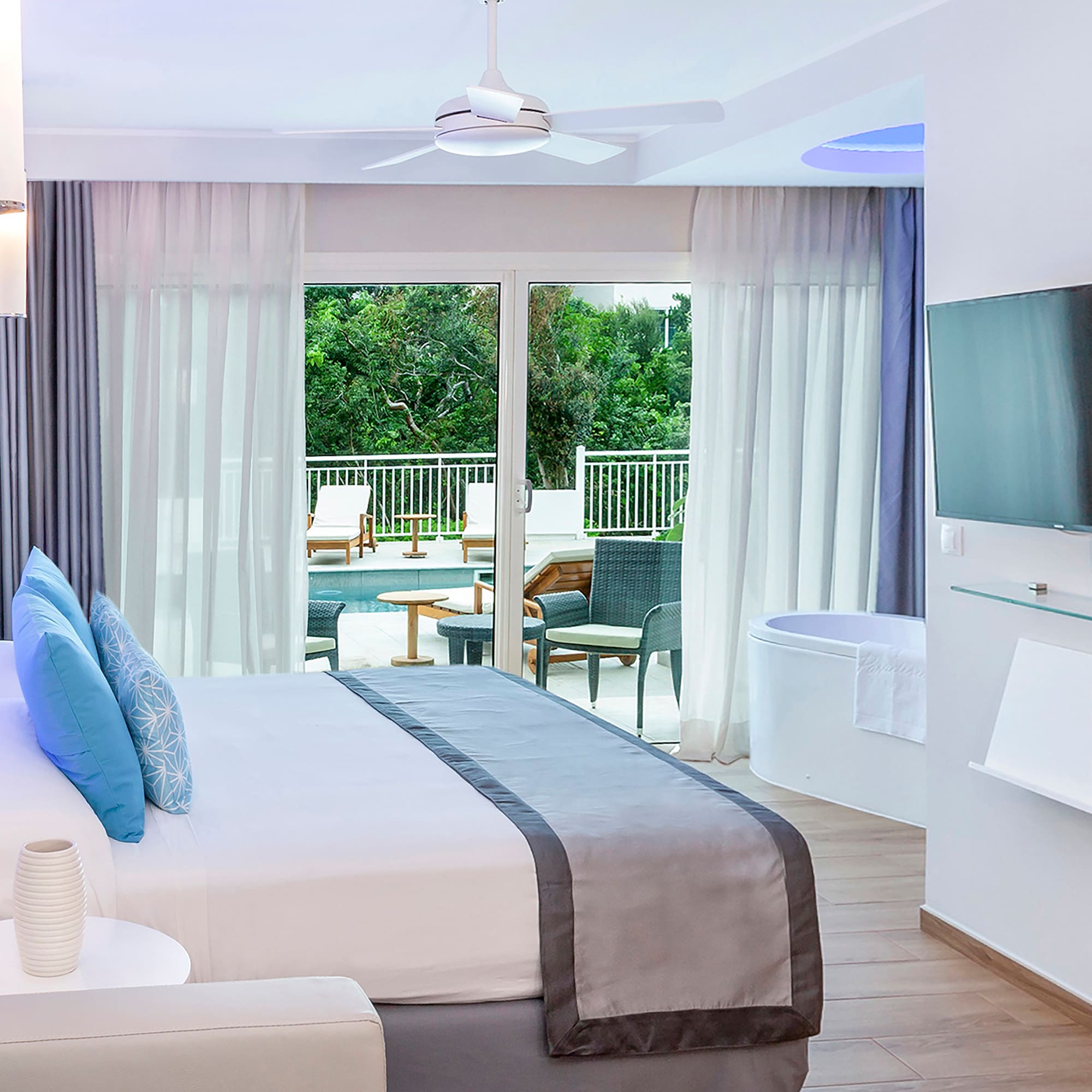 a bedroom with a large bed and a tub