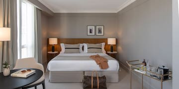 a bedroom with a bed and a table