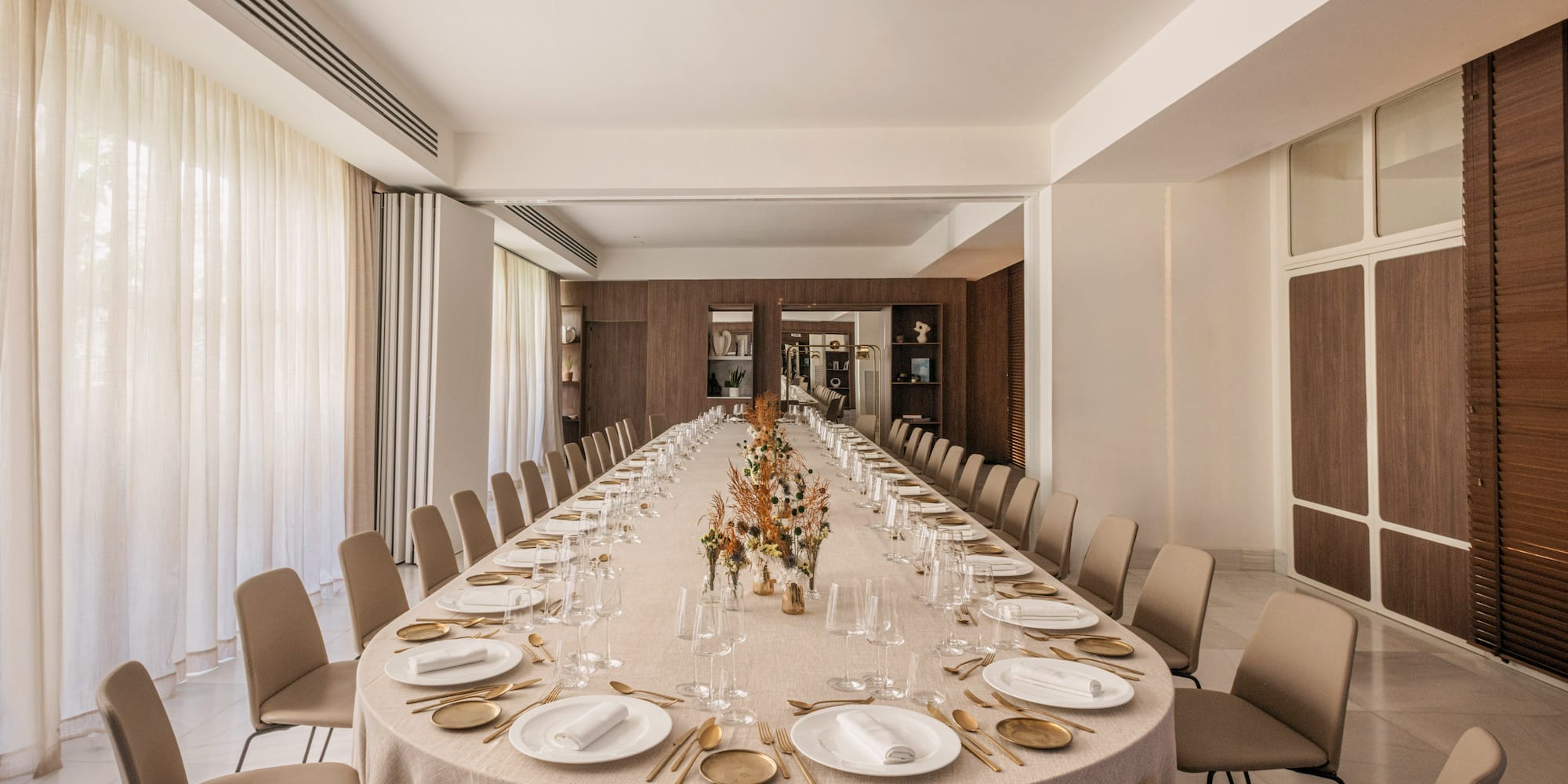 a long table with plates and glasses