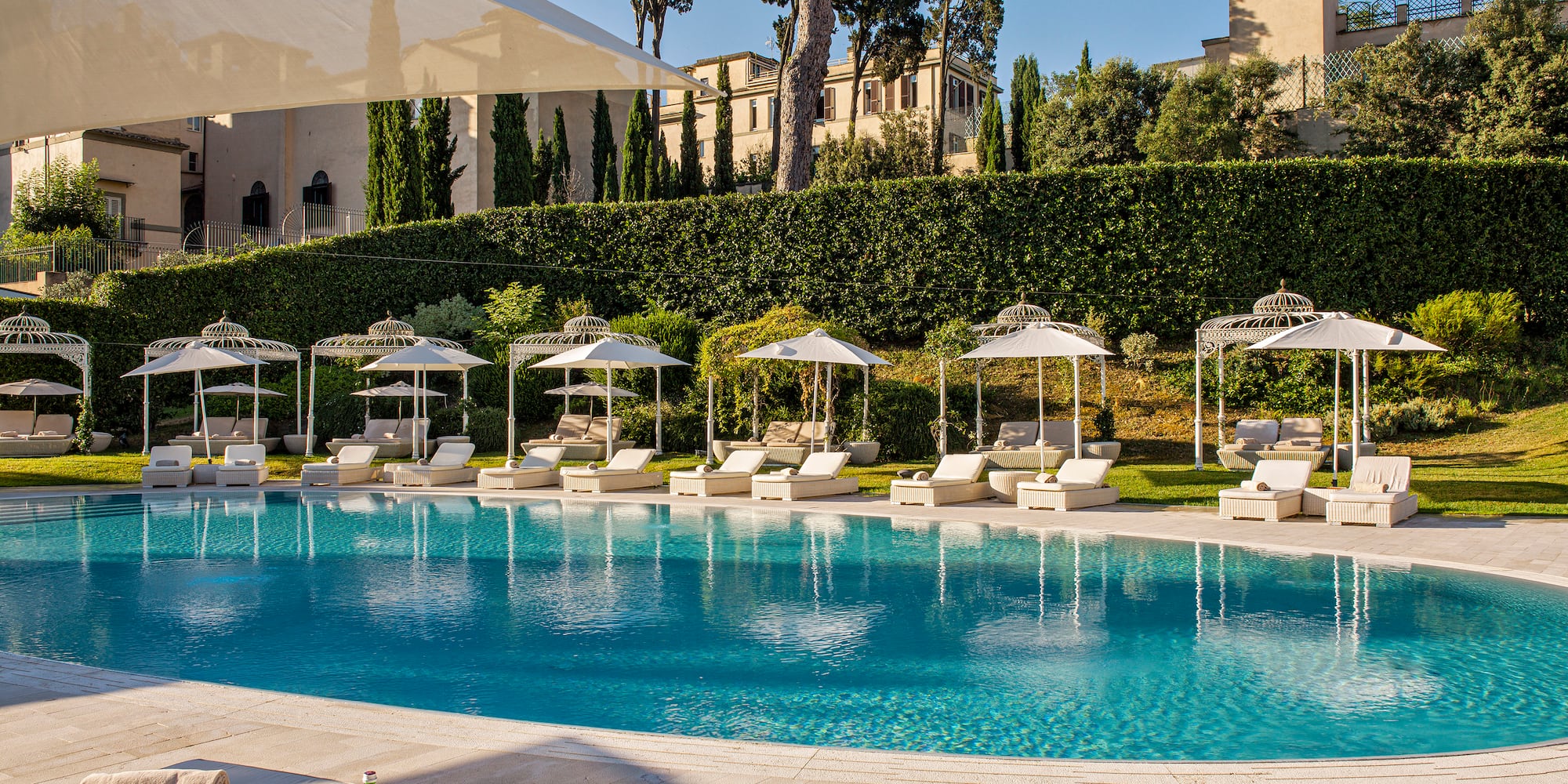 a pool with lounge chairs and umbrellas