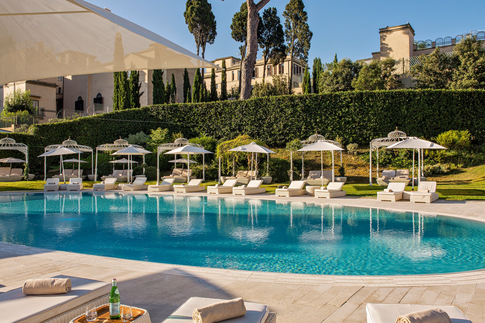 a pool with lounge chairs and umbrellas