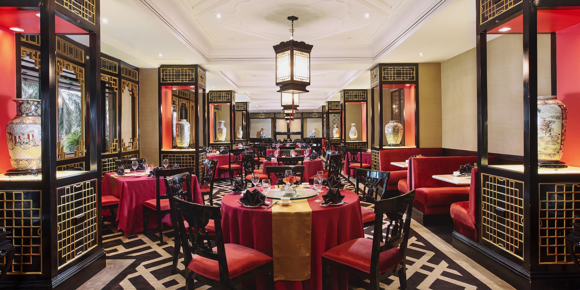 a restaurant with red and gold tables and chairs