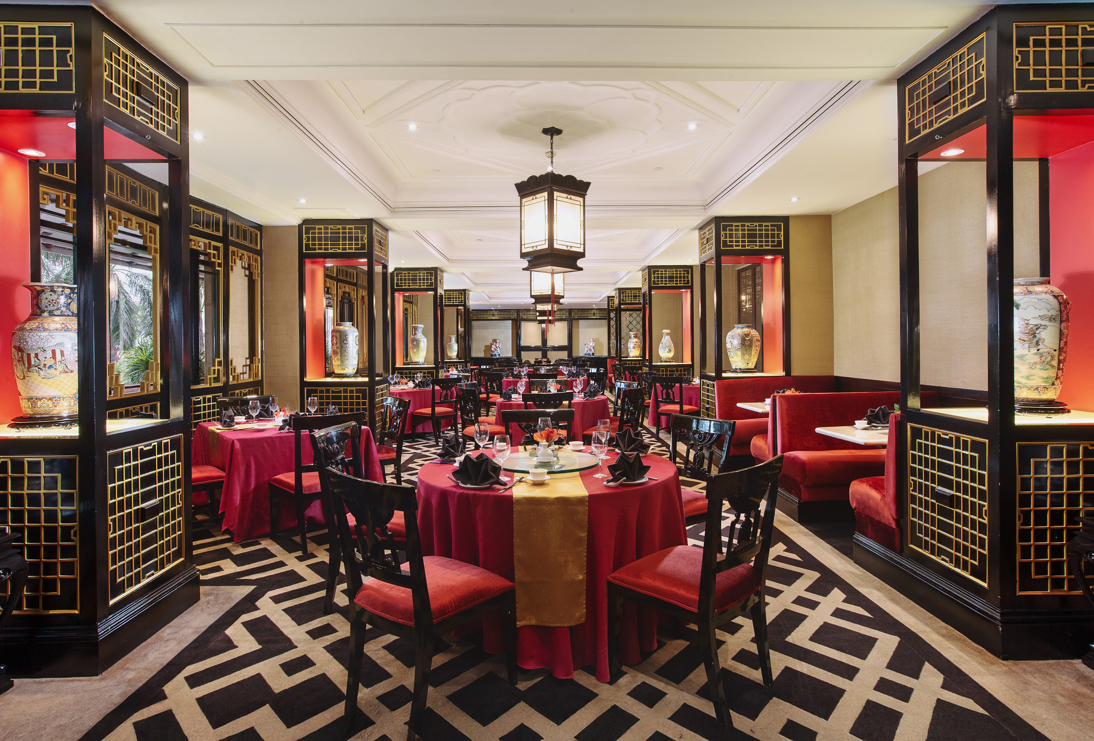 a restaurant with red and gold tables and chairs