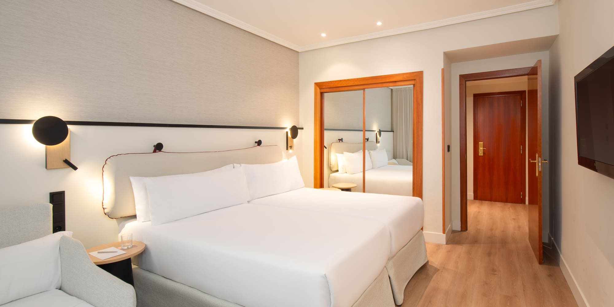 a room with two beds and a door