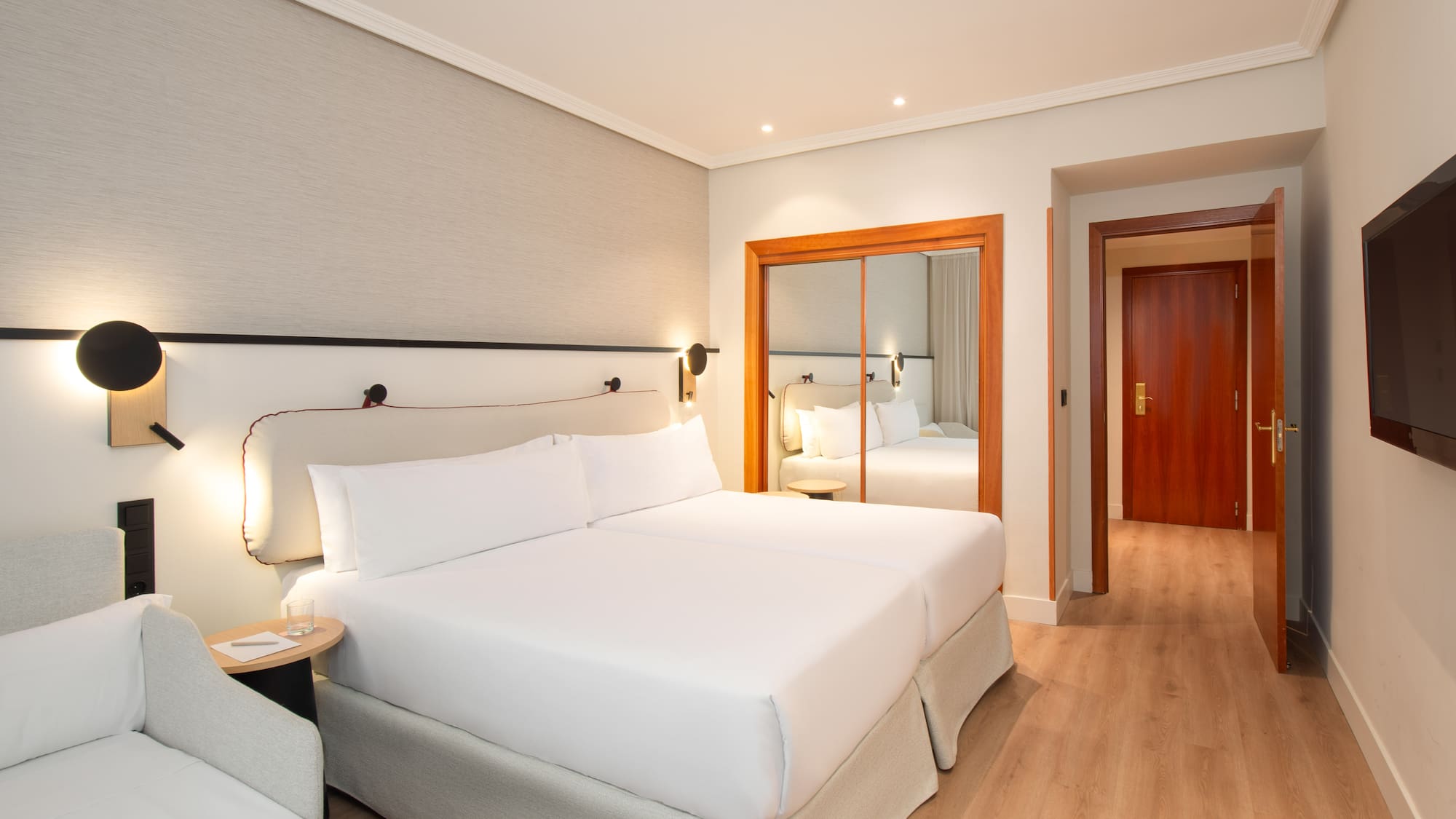 a room with two beds and a door