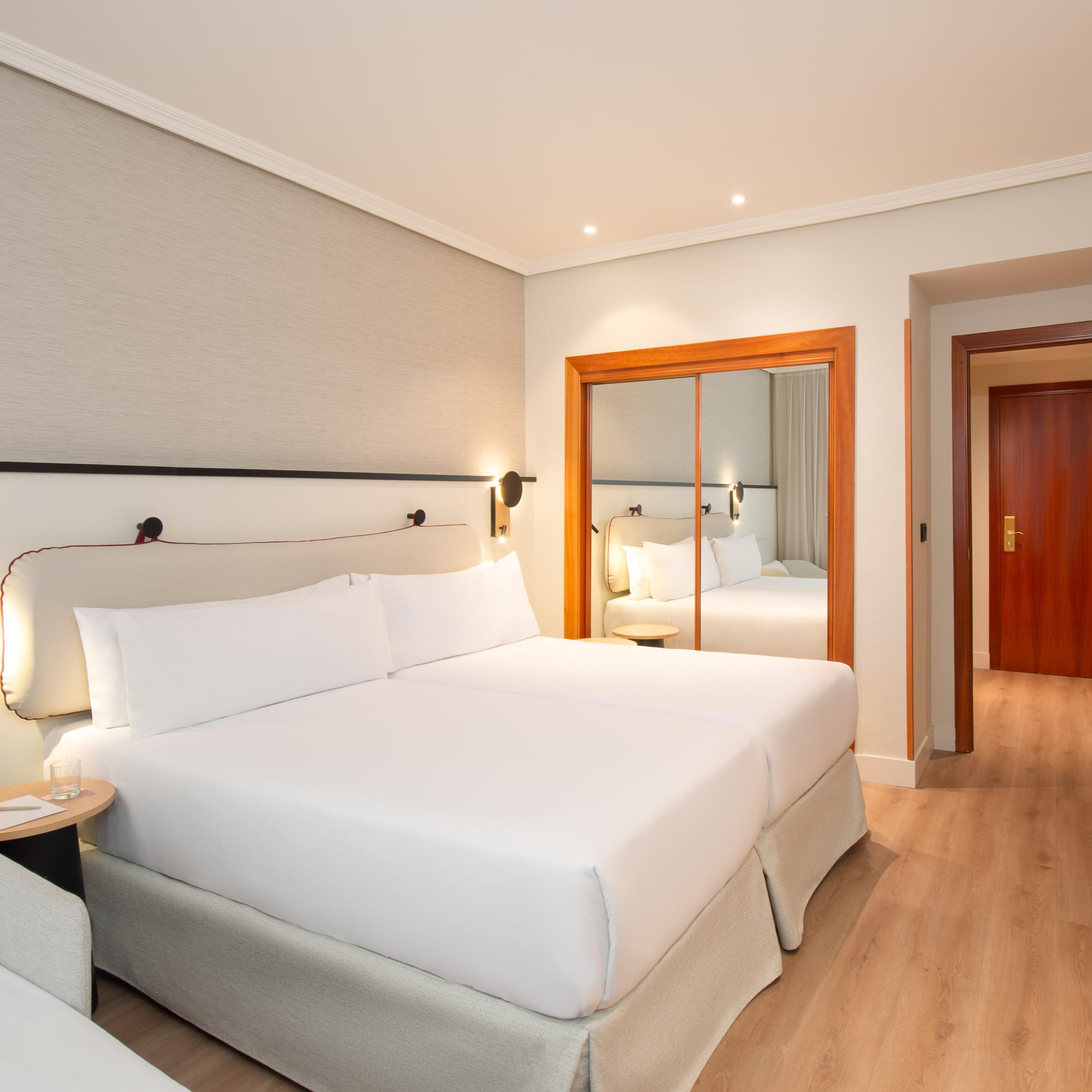 a room with two beds and a door