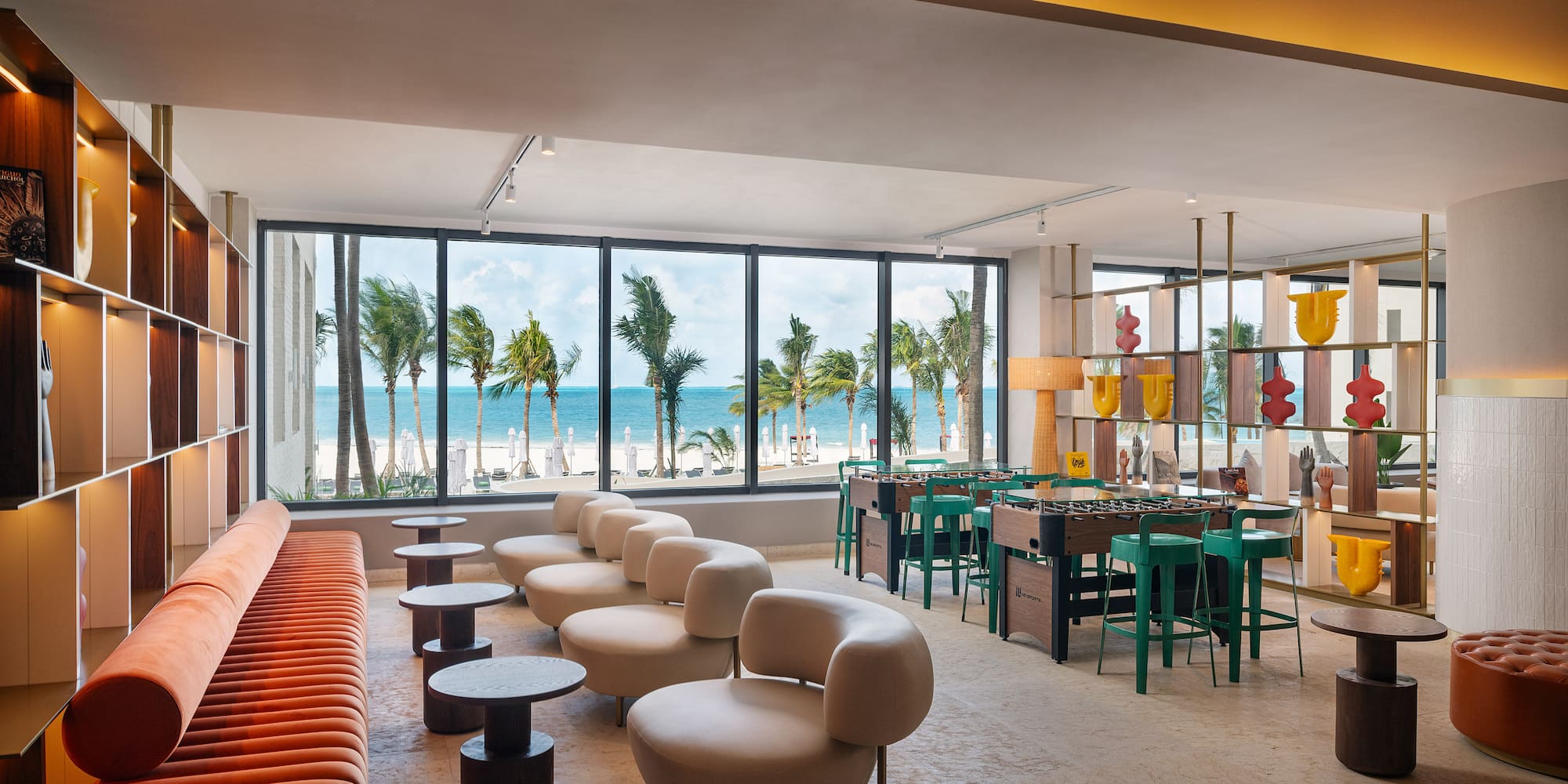 a room with a pool table and chairs