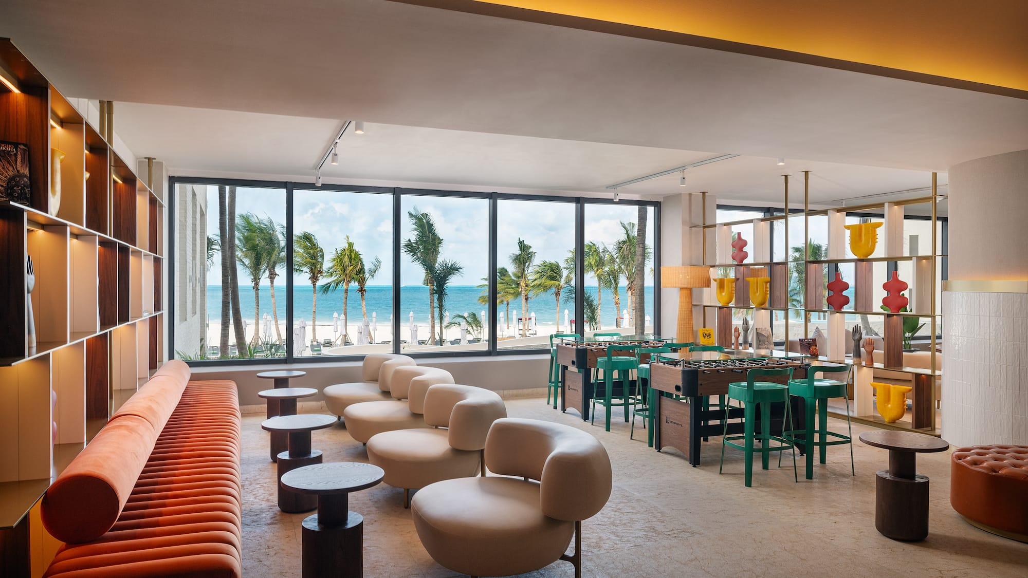 a room with a pool table and chairs