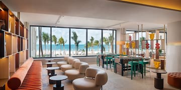 a room with a pool table and chairs