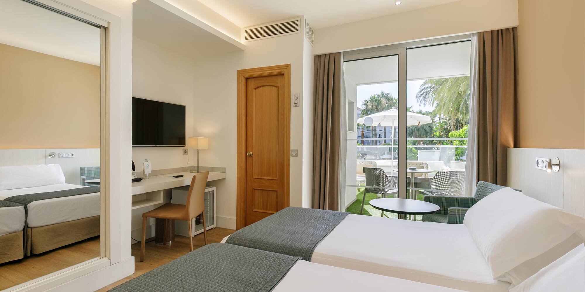 a room with two beds and a television