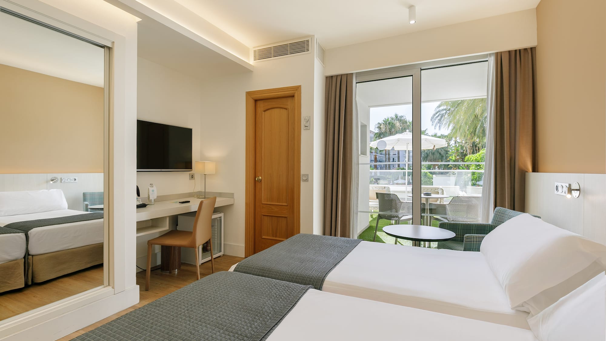 a room with two beds and a television