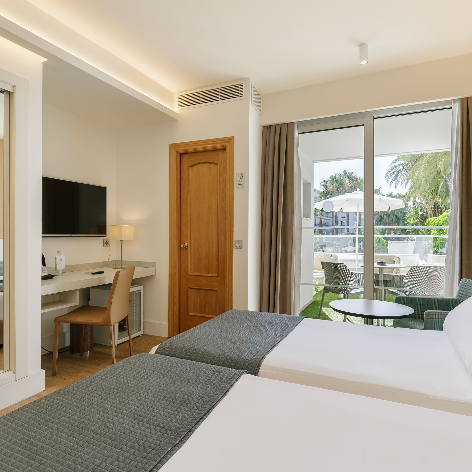 a room with two beds and a television