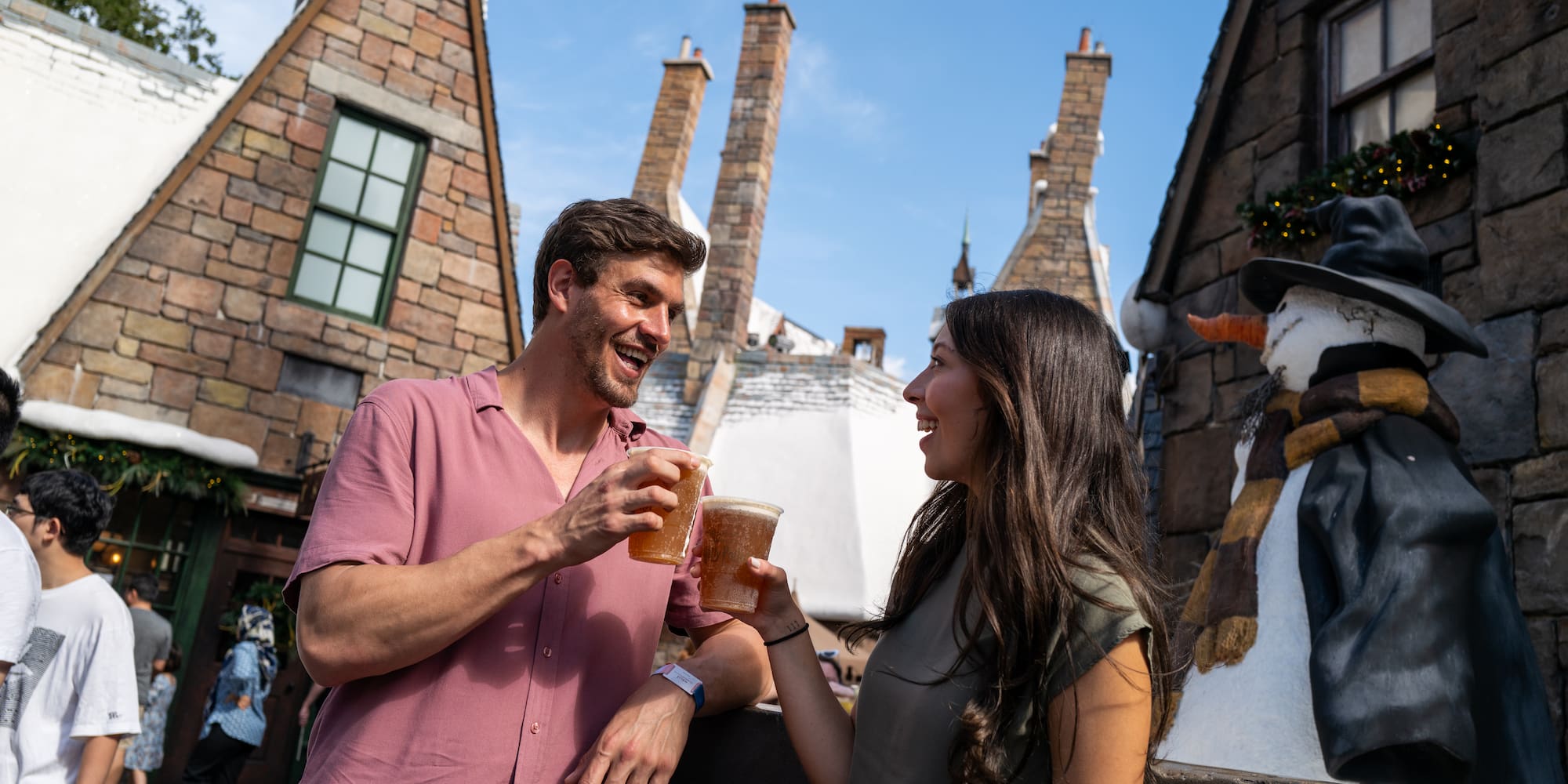 a man and woman holding glasses of beer