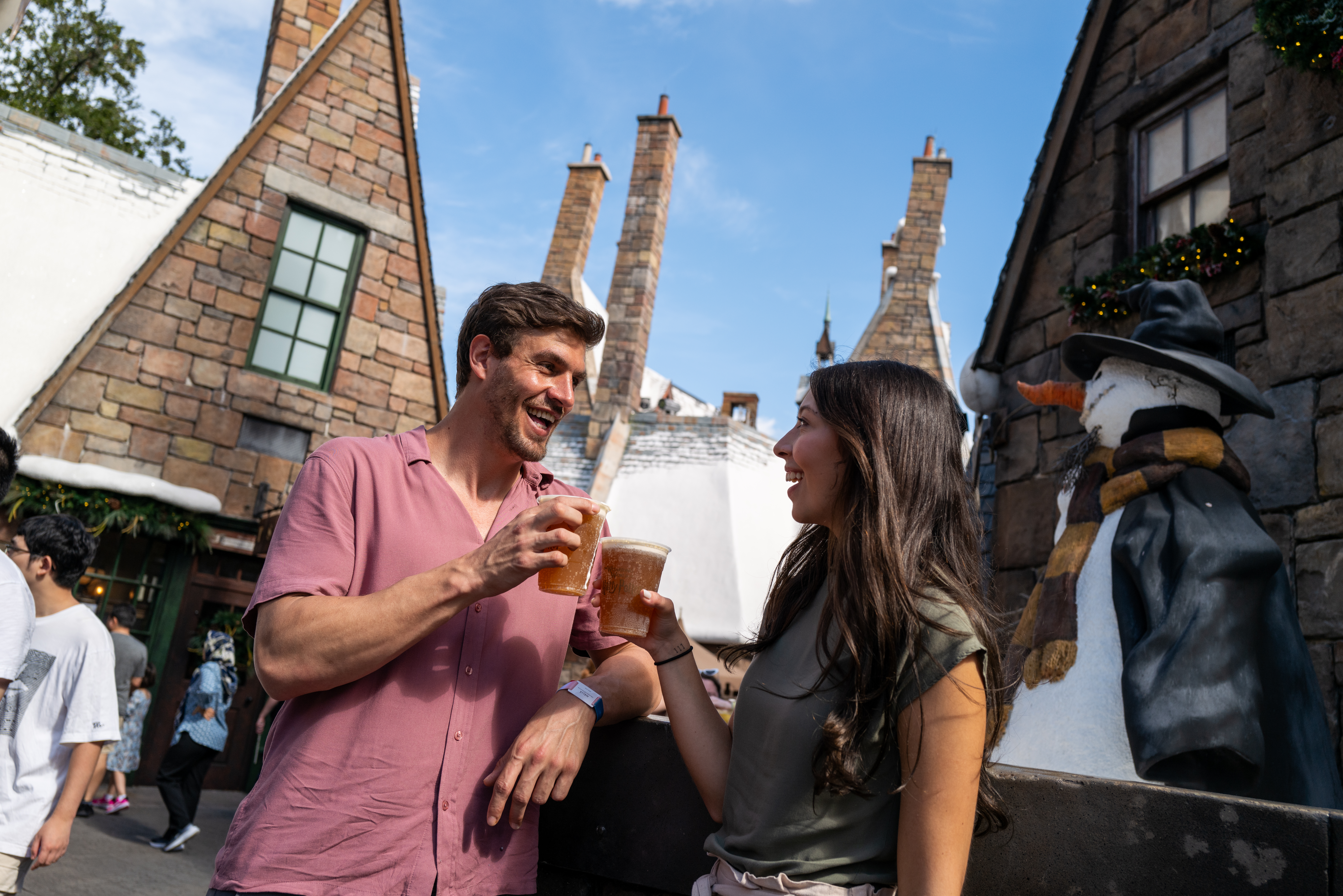 a man and woman holding glasses of beer