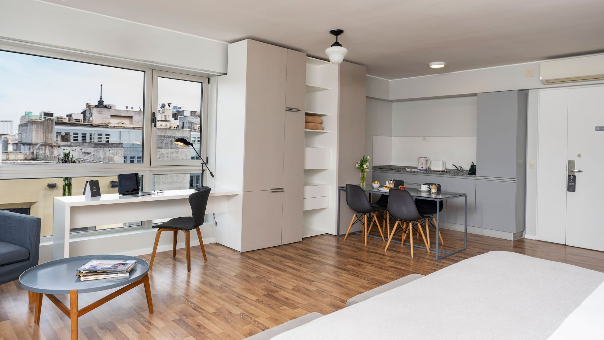 a room with a bed and a table and chairs