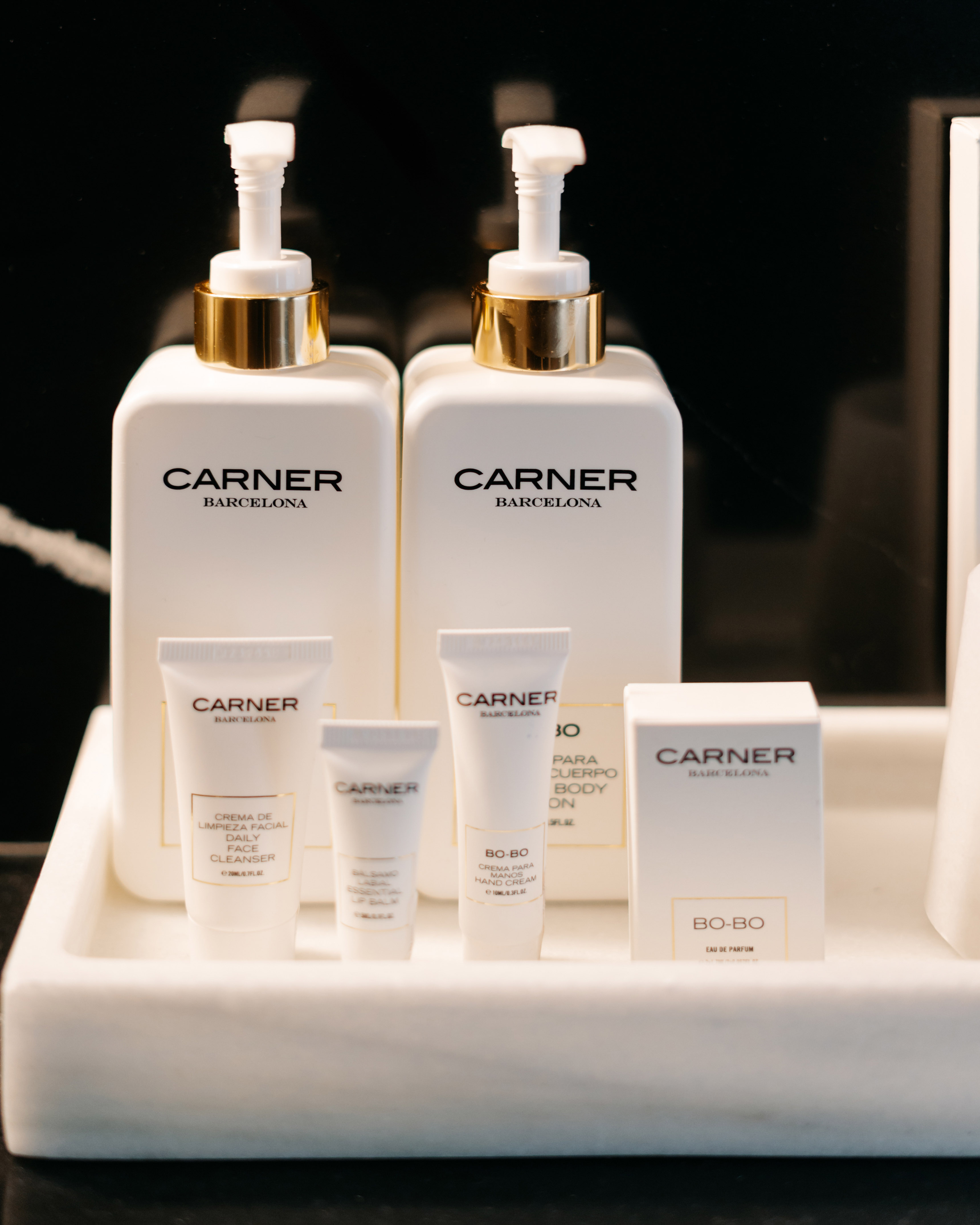Carner Barcelona luxury hotel amenities: skincare, body care, perfume.