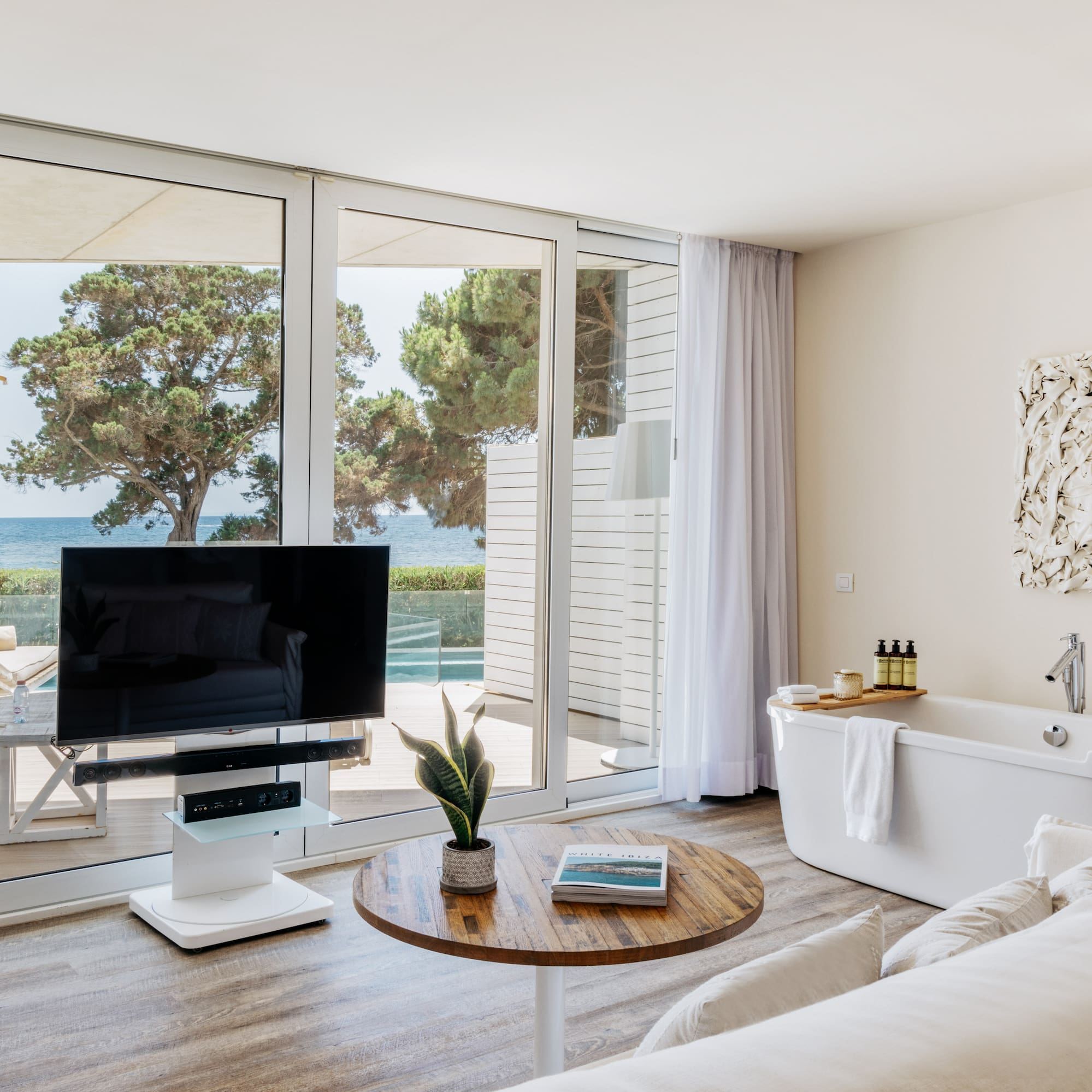 a living room with a television and a tub