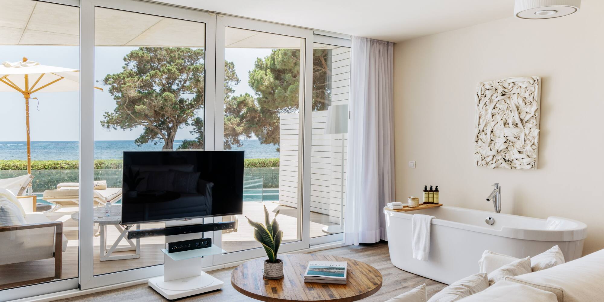 a living room with a television and a tub