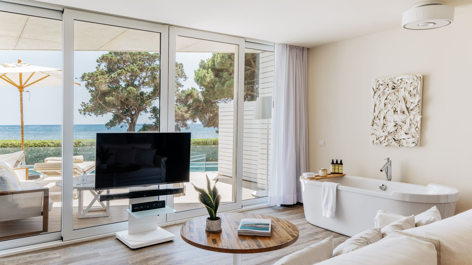 a living room with a television and a tub