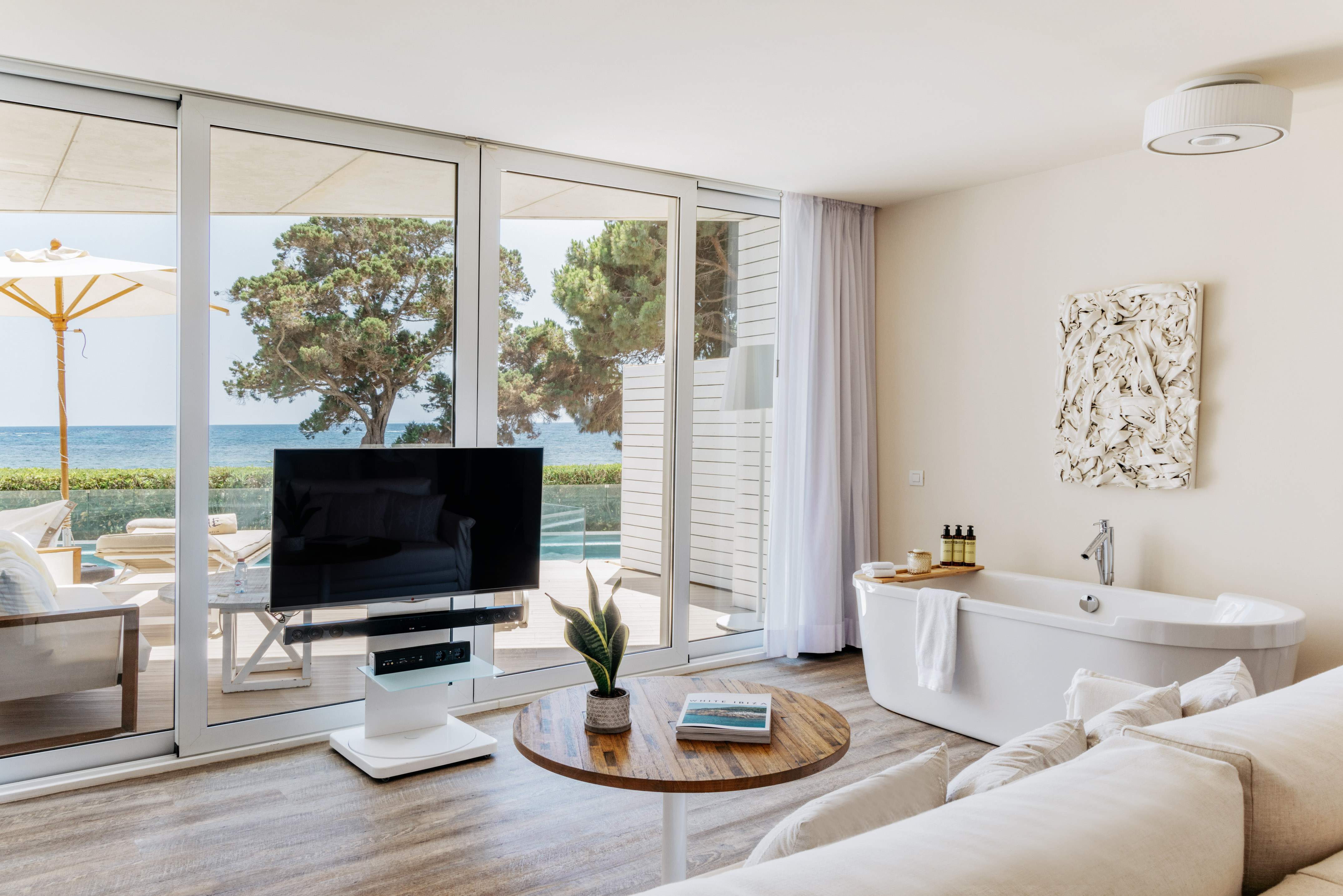 a living room with a television and a tub