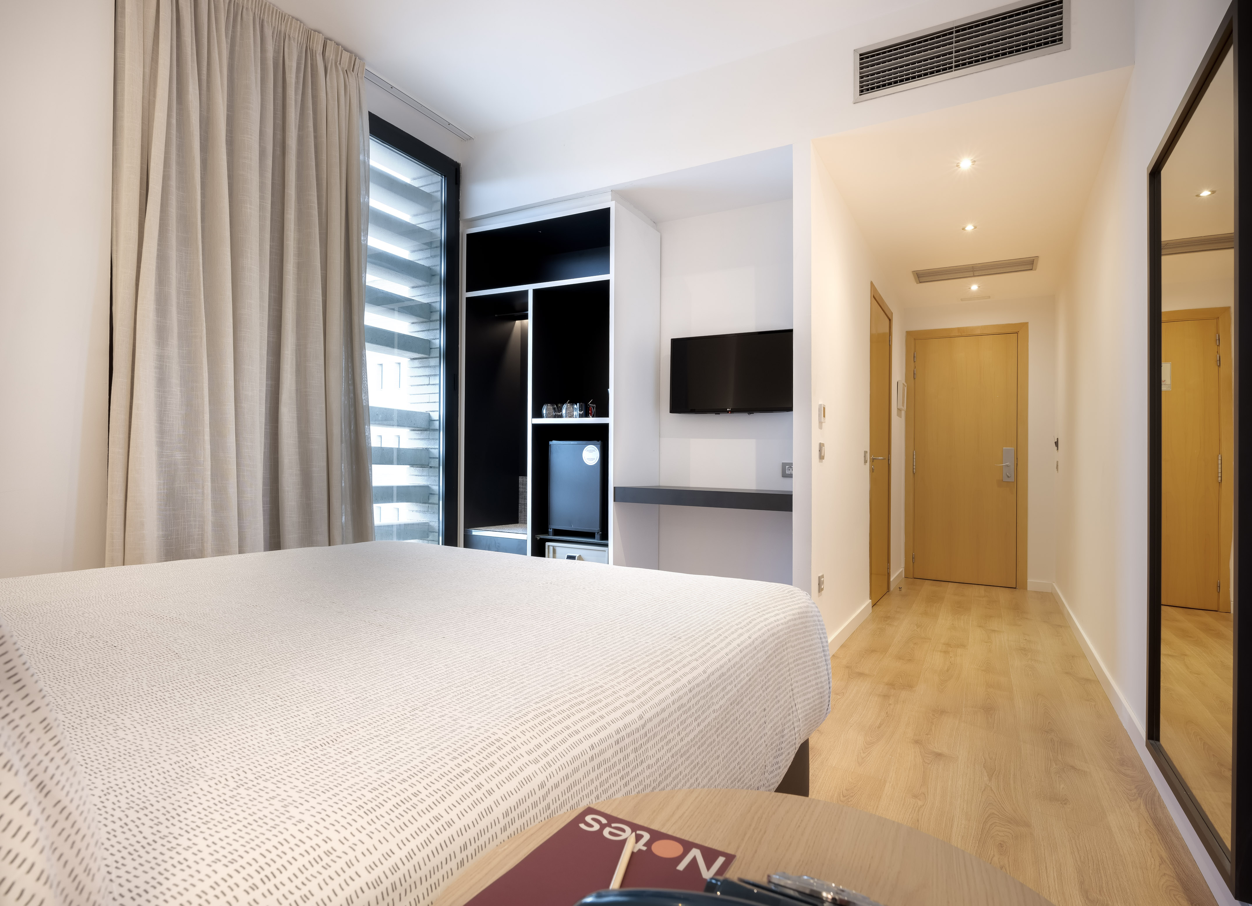 a room with a bed and a tv