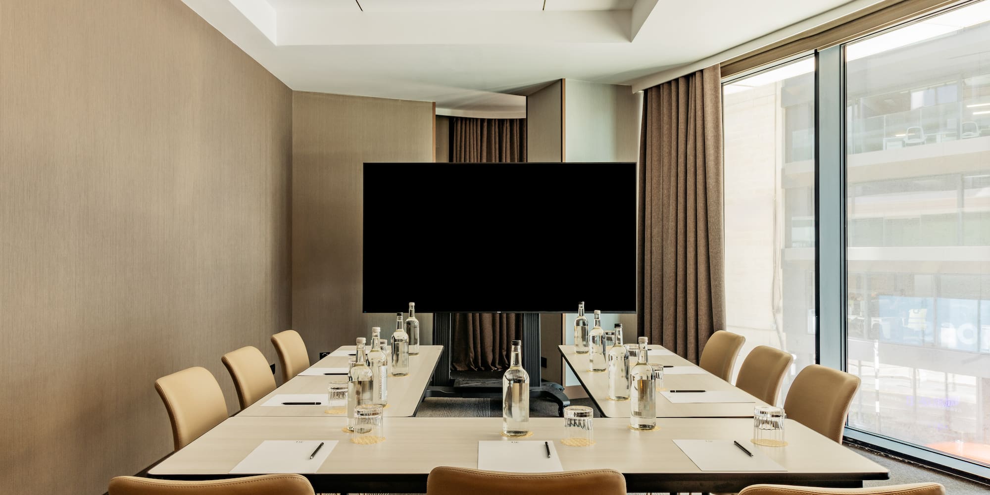 a conference room with a television and chairs