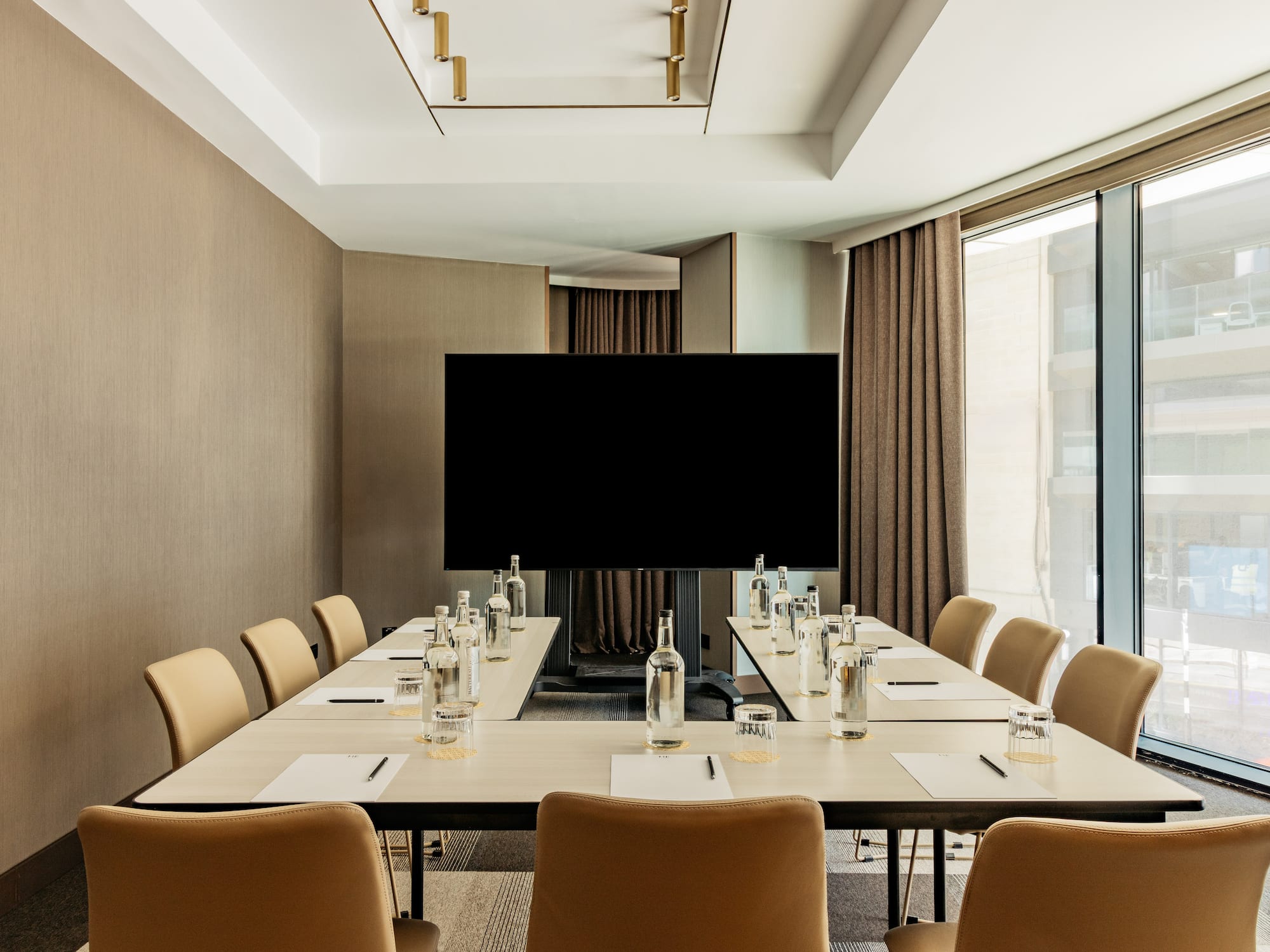 a conference room with a television and chairs