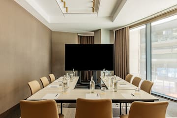 a conference room with a television and chairs
