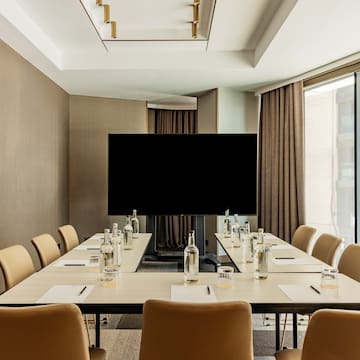 a conference room with a television and chairs