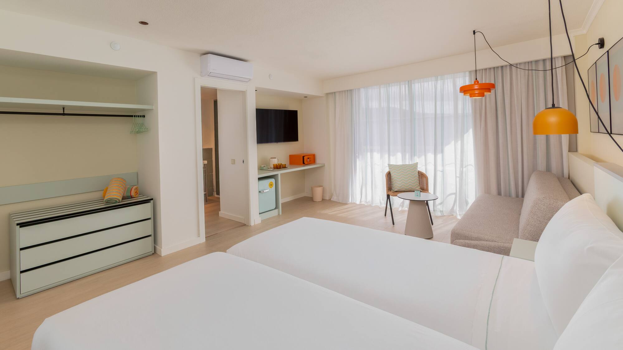 a room with two beds and a table