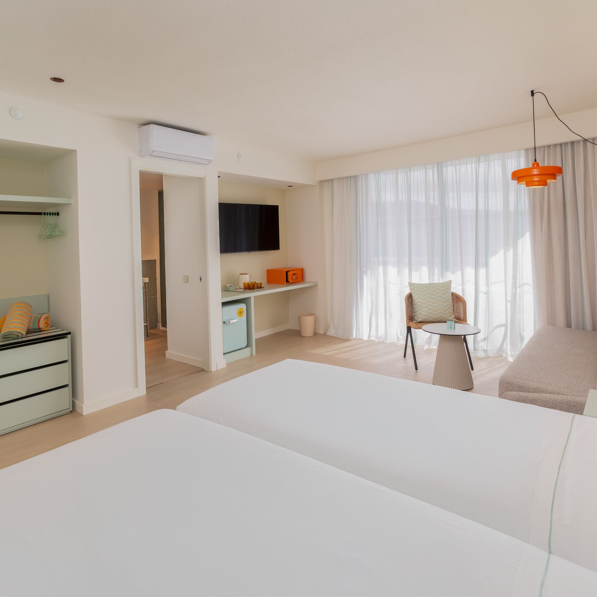 a room with two beds and a table