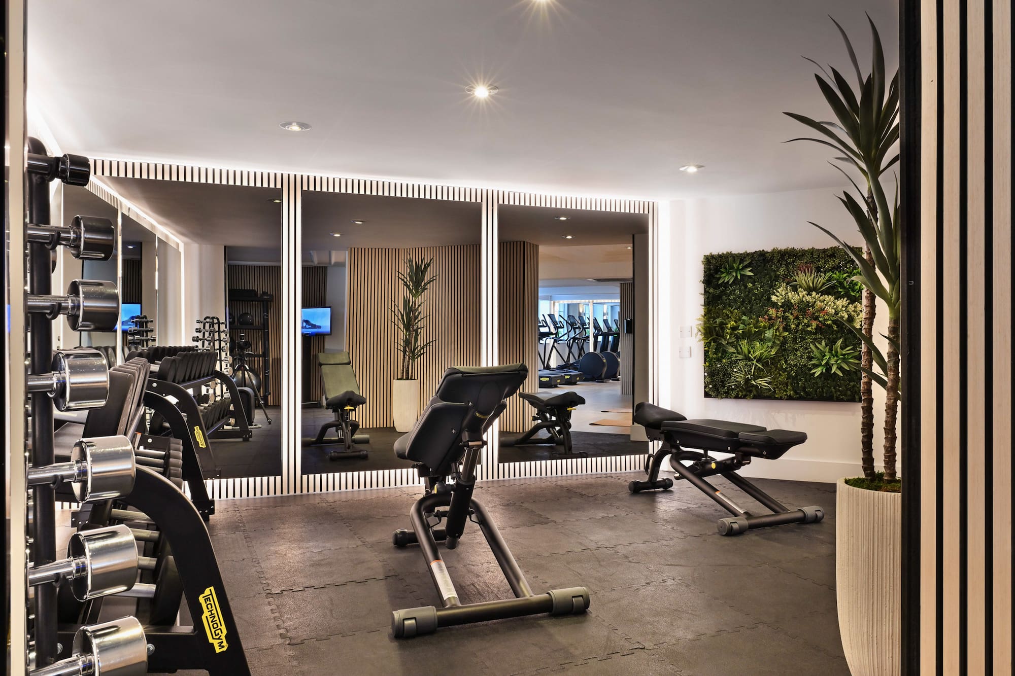 a room with exercise equipment and mirrors