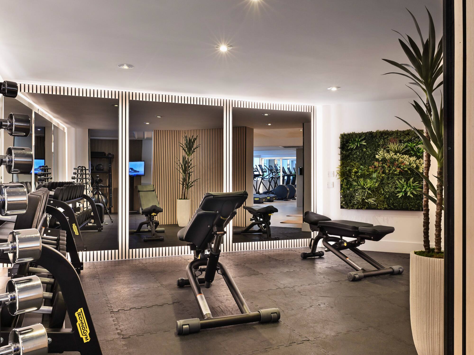 a room with exercise equipment and mirrors