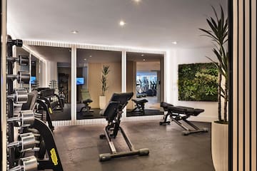 a room with exercise equipment and mirrors
