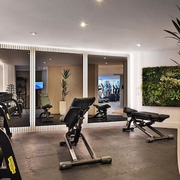 a room with exercise equipment and mirrors