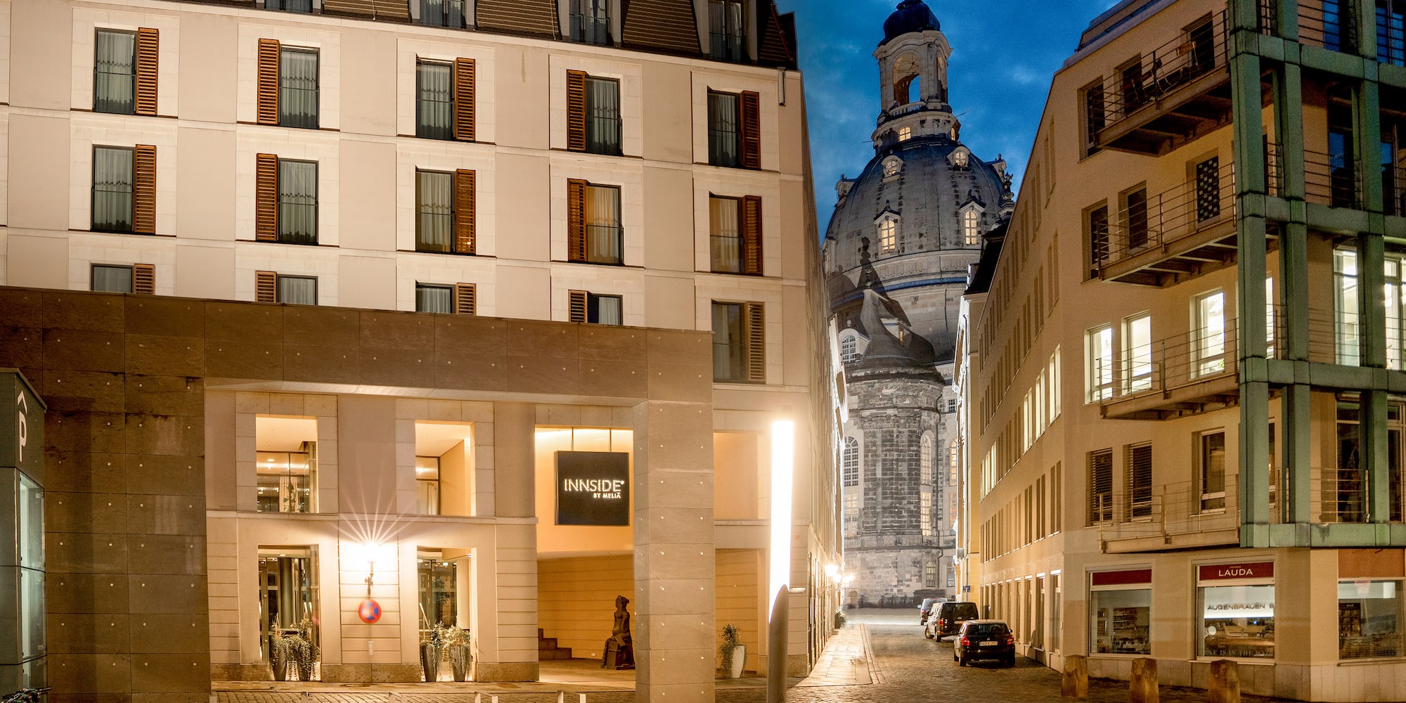 a street with buildings and a dome in the background