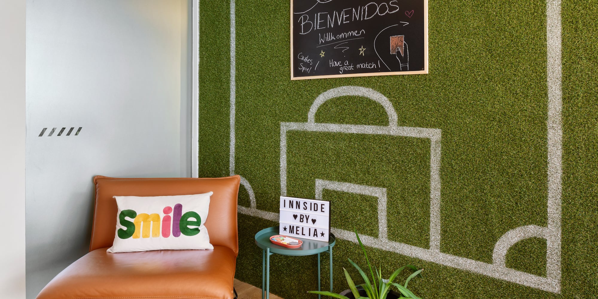 a chair and a table with a chalkboard on the wall